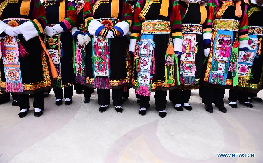 Women from Tu ethnic group dressed in folk costumes wait to perform during a celebration for "Er Yue Er" in Tu Autonomous County of Huzhu, northwest China's Qinghai Province, March 13, 2013, on the occasion of the second day of the second lunar month, known in Chinese as Er Yue Er, "a time for the dragon to raise its head", as a Chinese saying goes. Local residents gathered together and celebrated the festival with traditional performance. (Xinhua/Zhang Hongxiang) 