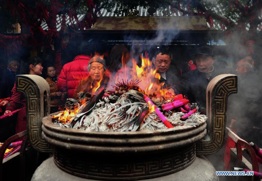 People burn incense at a temple fair for blessings to celebrate "Er Yue Er" in Wushan Township of Changfeng County, east China's Anhui Province, March 13, 2013, on the occasion of the second day of the second lunar month, known in Chinese as Er Yue Er, "a time for the dragon to raise its head", as a Chinese saying goes. Local residents celebrated the festival with traditional performance to commemorate the King of Wu kingdom and pray for a good harvest in the coming year. (Xinhua/Yu Junjie)