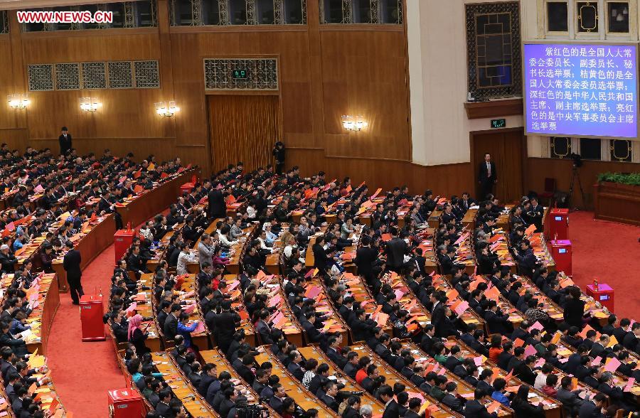 Deputies check their ballots at the fourth plenary meeting of the first session of the 12th National People's Congress (NPC) at the Great Hall of the People in Beijing, capital of China, March 14, 2013. Chairman, vice-chairpersons, secretary-general and members of the 12th NPC Standing Committee, president and vice-president of the state, and chairman of the Central Military Commission of the People's Republic of China will be elected here on Thursday. (Xinhua/Liu Weibing)