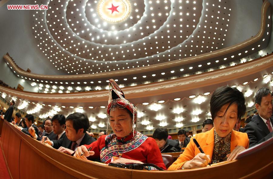 Deputies prepare to write their ballots at the fourth plenary meeting of the first session of the 12th National People's Congress (NPC) at the Great Hall of the People in Beijing, capital of China, March 14, 2013. Chairman, vice-chairpersons, secretary-general and members of the 12th NPC Standing Committee, president and vice-president of the state, and chairman of the Central Military Commission of the People's Republic of China will be elected here on Thursday. (Xinhua/Chen Jianli)