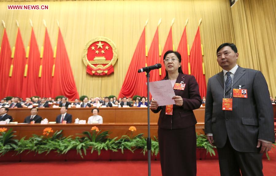 The head of the intendancy announces checking results of ballot boxes at the fourth plenary meeting of the first session of the 12th National People's Congress (NPC) at the Great Hall of the People in Beijing, capital of China, March 14, 2013. Chairman, vice-chairpersons, secretary-general and members of the 12th NPC Standing Committee, president and vice-president of the state, and chairman of the Central Military Commission of the People's Republic of China will be elected here on Thursday. (Xinhua/Lan Hongguang)