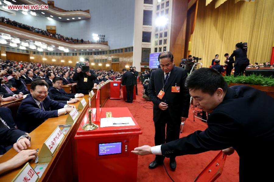 Members of the intendancy check a ballot box at the fourth plenary meeting of the first session of the 12th National People's Congress (NPC) at the Great Hall of the People in Beijing, capital of China, March 14, 2013. Chairman, vice-chairpersons, secretary-general and members of the 12th NPC Standing Committee, president and vice-president of the state, and chairman of the Central Military Commission of the People's Republic of China will be elected here on Thursday. (Xinhua/Pang Xinglei)