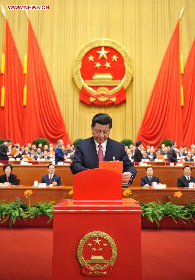 Xi Jinping casts ballots at the fourth plenary meeting of the first session of the 12th National People's Congress (NPC) at the Great Hall of the People in Beijing, capital of China, March 14, 2013. Chairman, vice-chairpersons, secretary-general and members of the 12th NPC Standing Committee, president and vice-president of the state, and chairman of the Central Military Commission of the People's Republic of China will be elected here on Thursday. (Xinhua/Huang Jingwen)
