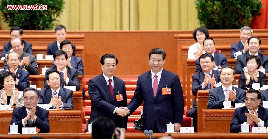 Hu Jintao congratulates Xi Jinping at the fourth plenary meeting of the first session of the 12th National People's Congress (NPC) in Beijing, capital of China, March 14, 2013. Xi was elected president of the People's Republic of China (PRC) and chairman of the Central Military Commission of the PRC at the NPC session here on Thursday. (Xinhua/Liu Jiansheng)