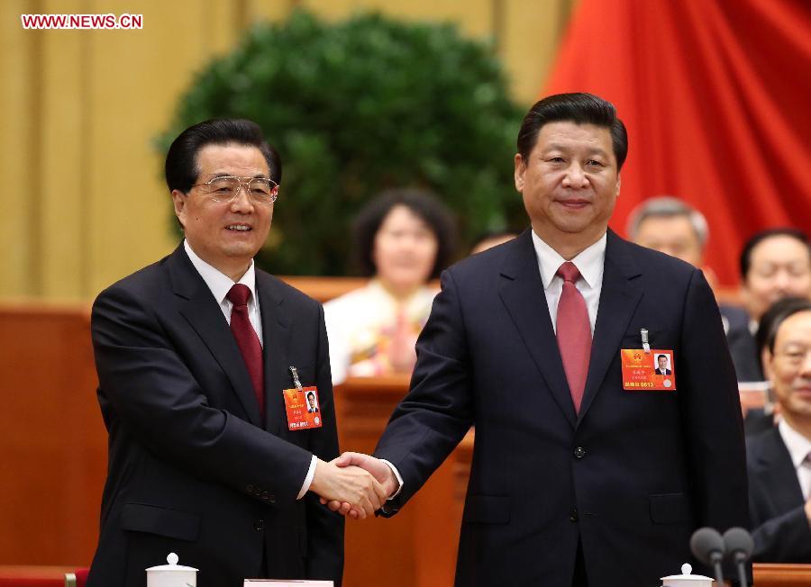 Hu Jintao (L) congratulates Xi Jinping at the fourth plenary meeting of the first session of the 12th National People's Congress (NPC) in Beijing, capital of China, March 14, 2013. Xi was elected president of the People's Republic of China (PRC) and chairman of the Central Military Commission of the PRC at the NPC session here on Thursday. (Xinhua/Pang Xinglei)
