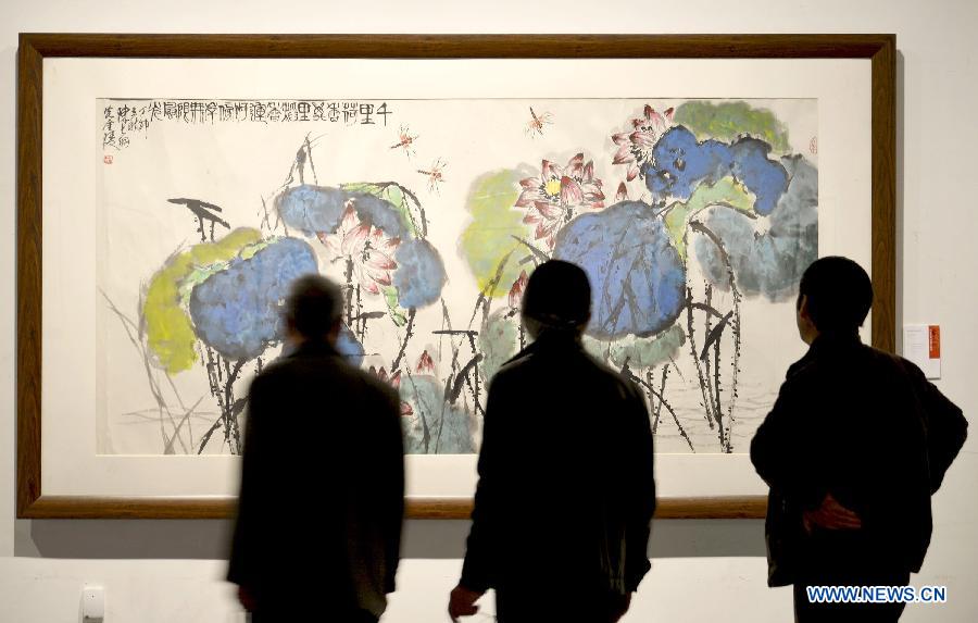 Visitors view a work of inkwash painter Chen Dayu (1912-2001) during the exhibition "No End for Art" at the Zhejiang Art Museum in Hangzhou, capital of east China's Zhejiang Province, March 14, 2013. Some 140 pieces of Chen Dayu's inkwash paintings created between 1945 and 2001 were shown at the exhibition, which was inaugurated Thursday in Hangzhou. Chen was a student of Qi Baishi, another inkwash painting master, and specialised in drawing flowers and birds. (Xinhua/Shi Jianxue) 