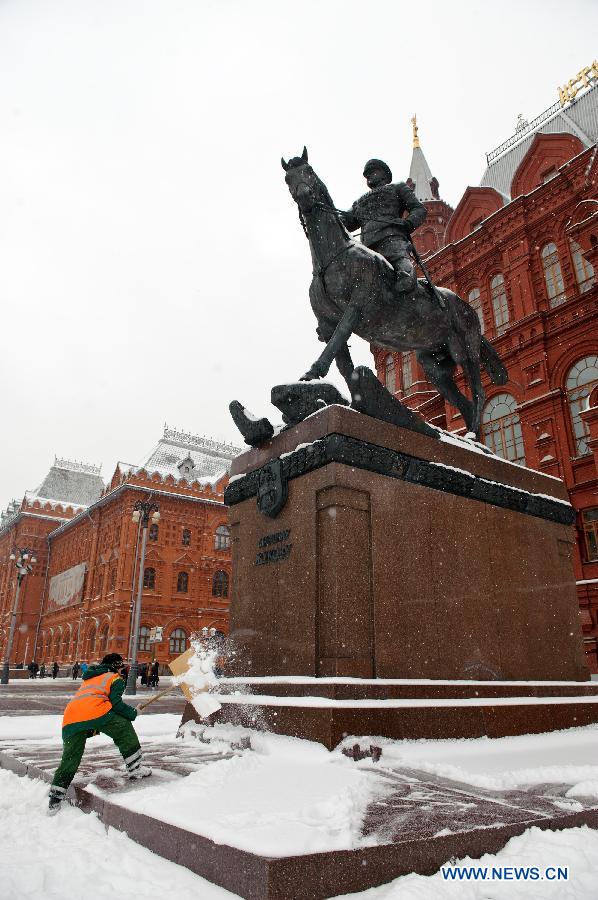 A worker clears snow in Moscow, Russia, March 14, 2013. A rare heavy snowfall hit Moscow on Wednesday and Thursday, causing traffic jams and disturbing scheduled flights. (Xinhua/Jiang Kehong) 