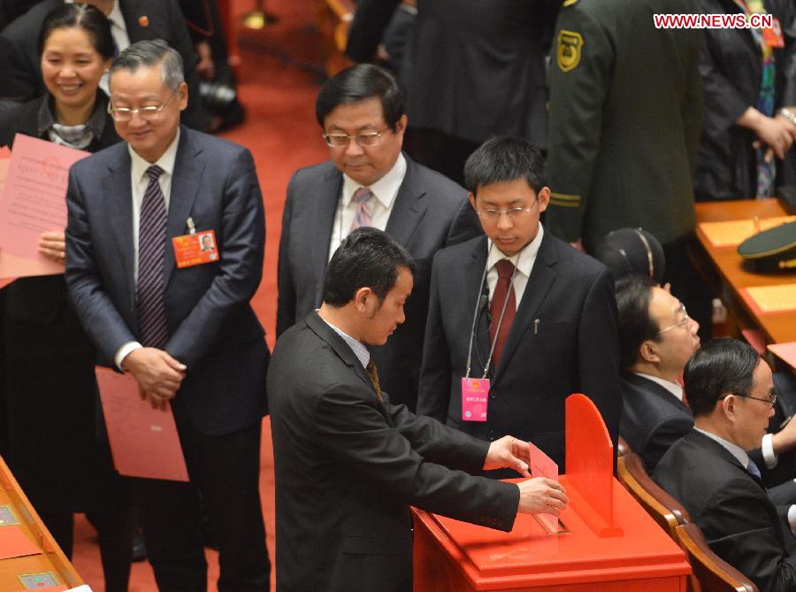A deputy casts his vote at the fifth plenary meeting of the first session of the 12th National People's Congress (NPC) at the Great Hall of the People in Beijing, capital of China, March 15, 2013. The meeting will vote to decide on the premier, as well as vice chairpersons and members of the Central Military Commission of the People's Republic of China. President of the Supreme People's Court and procurator-general of the Supreme People's Procuratorate will also be elected. (Xinhua/Wang Song)