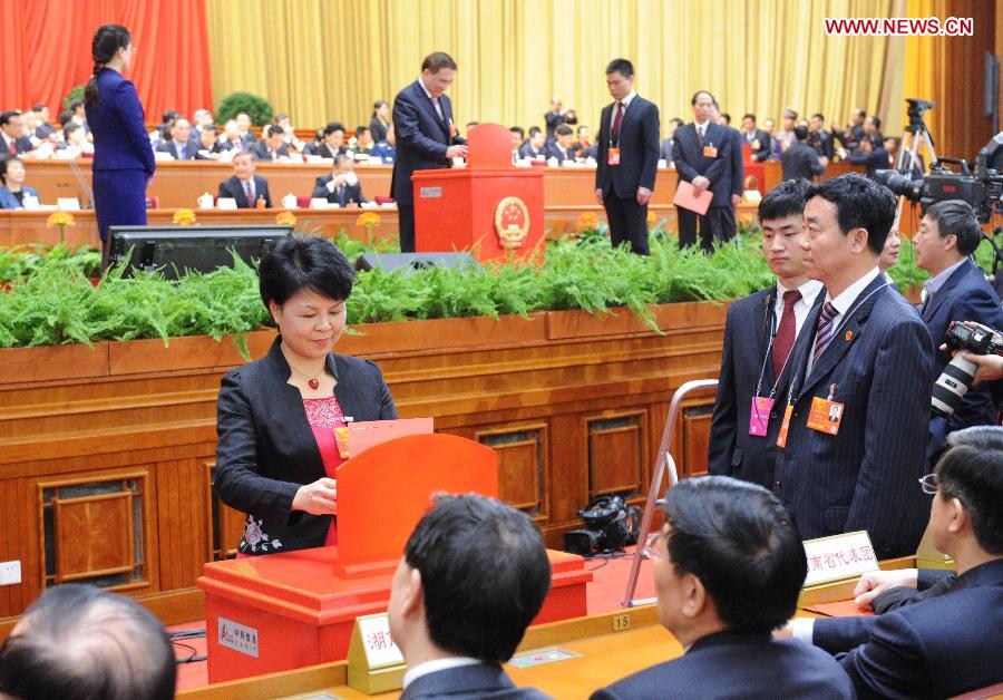 A deputy casts her vote at the fifth plenary meeting of the first session of the 12th National People's Congress (NPC) at the Great Hall of the People in Beijing, capital of China, March 15, 2013. The meeting will vote to decide on the premier, as well as vice chairpersons and members of the Central Military Commission of the People's Republic of China. President of the Supreme People's Court and procurator-general of the Supreme People's Procuratorate will also be elected. (Xinhua/Liu Jiansheng)