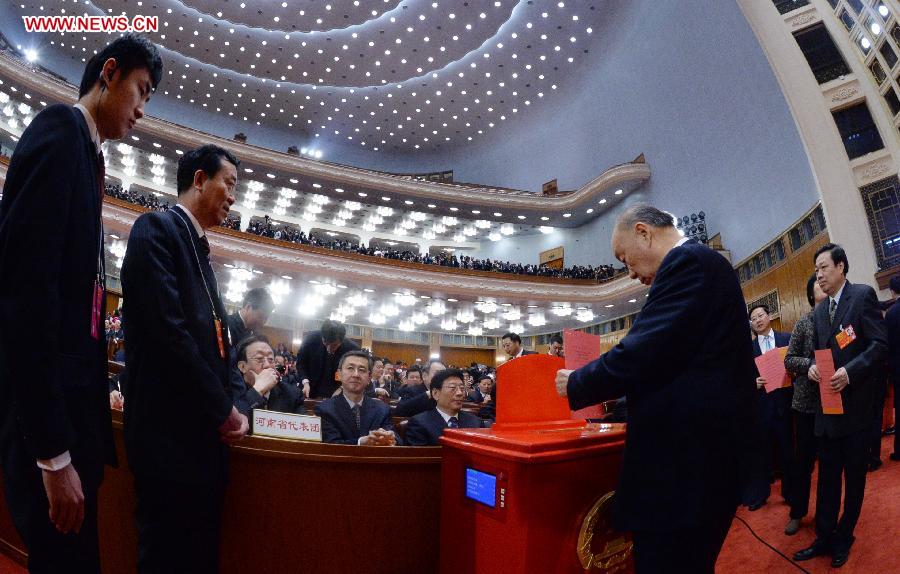A deputy casts his vote at the fifth plenary meeting of the first session of the 12th National People's Congress (NPC) at the Great Hall of the People in Beijing, capital of China, March 15, 2013. The meeting will vote to decide on the premier, as well as vice chairpersons and members of the Central Military Commission of the People's Republic of China. President of the Supreme People's Court and procurator-general of the Supreme People's Procuratorate will also be elected. (Xinhua/Liu Jiansheng)