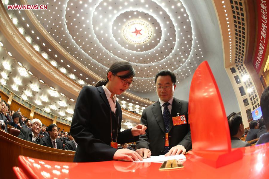 Members of the intendancy check a ballot box at the fifth plenary meeting of the first session of the 12th National People's Congress (NPC) at the Great Hall of the People in Beijing, capital of China, March 15, 2013. The meeting will vote to decide on the premier, as well as vice chairpersons and members of the Central Military Commission of the People's Republic of China. President of the Supreme People's Court and procurator-general of the Supreme People's Procuratorate will also be elected. (Xinhua/Chen Jianli)