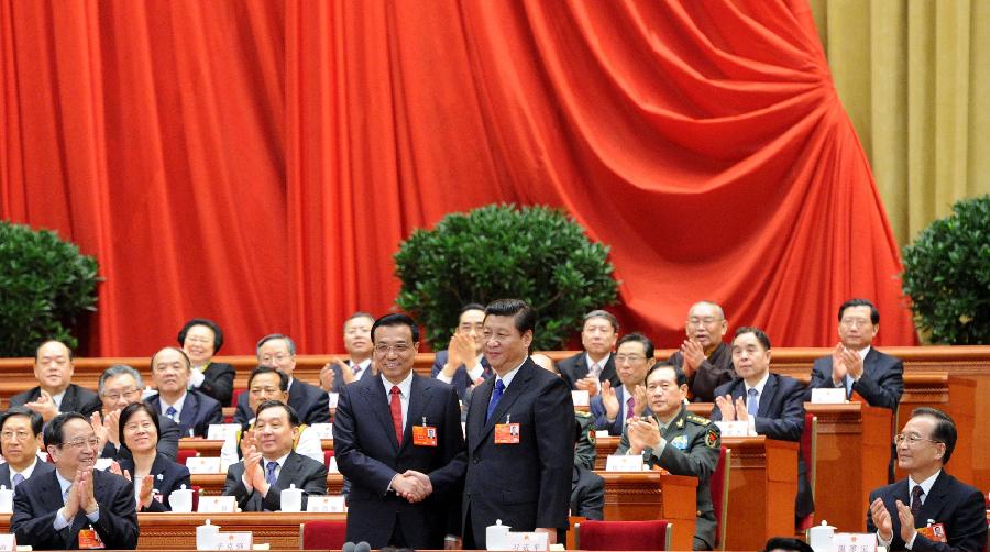 Xi Jinping shakes hands with Li Keqiang at the fifth plenary meeting of the first session of the 12th National People's Congress (NPC) at the Great Hall of the People in Beijing, capital of China, March 15, 2013. Li Keqiang was endorsed as the premier of China's State Council at the meeting here on Friday. (Xinhua/Liu Jiansheng)