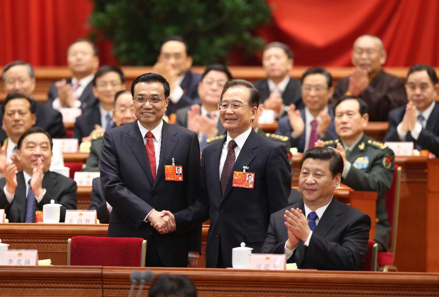 Wen Jiabao (2nd L, front) shakes hands with Li Keqiang at the fifth plenary meeting of the first session of the 12th National People's Congress (NPC) at the Great Hall of the People in Beijing, capital of China, March 15, 2013. Li Keqiang was endorsed as the premier of China's State Council at the meeting here on Friday. (Xinhua/Ding Lin)