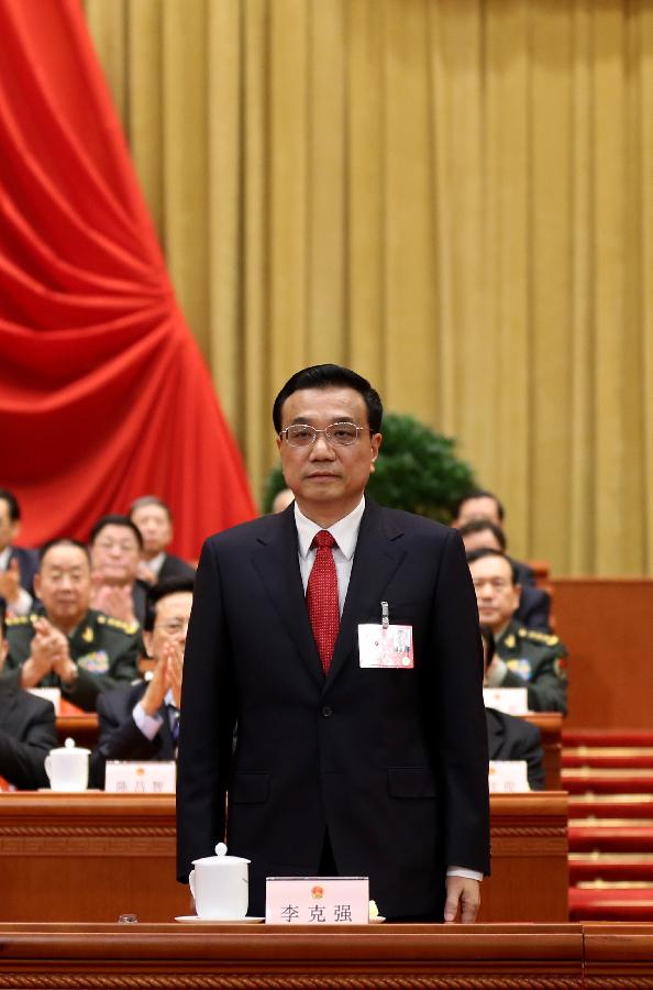 Li Keqiang greets all deputies at the fifth plenary meeting of the first session of the 12th National People's Congress (NPC) at the Great Hall of the People in Beijing, capital of China, March 15, 2013. Li Keqiang was endorsed as the premier of China's State Council at the meeting here on Friday. (Xinhua/Lan Hongguang)