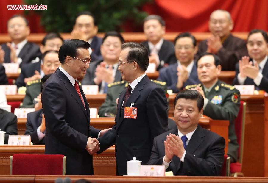 Wen Jiabao (2nd L, front) shakes hands with Li Keqiang at the fifth plenary meeting of the first session of the 12th National People's Congress (NPC) at the Great Hall of the People in Beijing, capital of China, March 15, 2013. Li Keqiang was endorsed as the premier of China's State Council at the meeting here on Friday. (Xinhua/Ding Lin) 