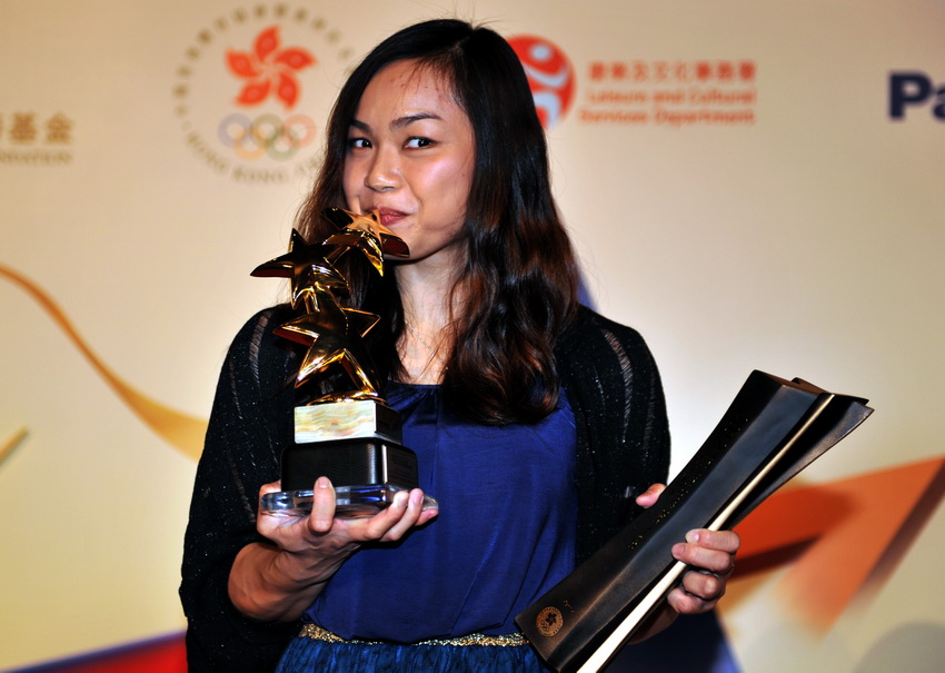 Chinese cyclist Sarah Lee Wai Sze from Hong Kong, Bronze Medalist of the Women's Keirin in London 2012 Olympic Games, is awarded the "Best of the Best Hong Kong Sports Stars Award" at the Hong Kong Convention and Exhibition Centre on March 14, 2013. (Xinhua/Lu Binghui)