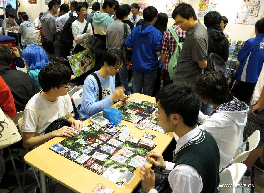 Visitors learn to play a card game at C3 in Hong Kong 2013, a Japanese anime (animation products) expo, in south China's Hong Kong, March 15, 2013. The three-day expo was inaugurated Friday at the Hong Kong Convention and Exhibition Centre. (Xinhua/Li Ying) 