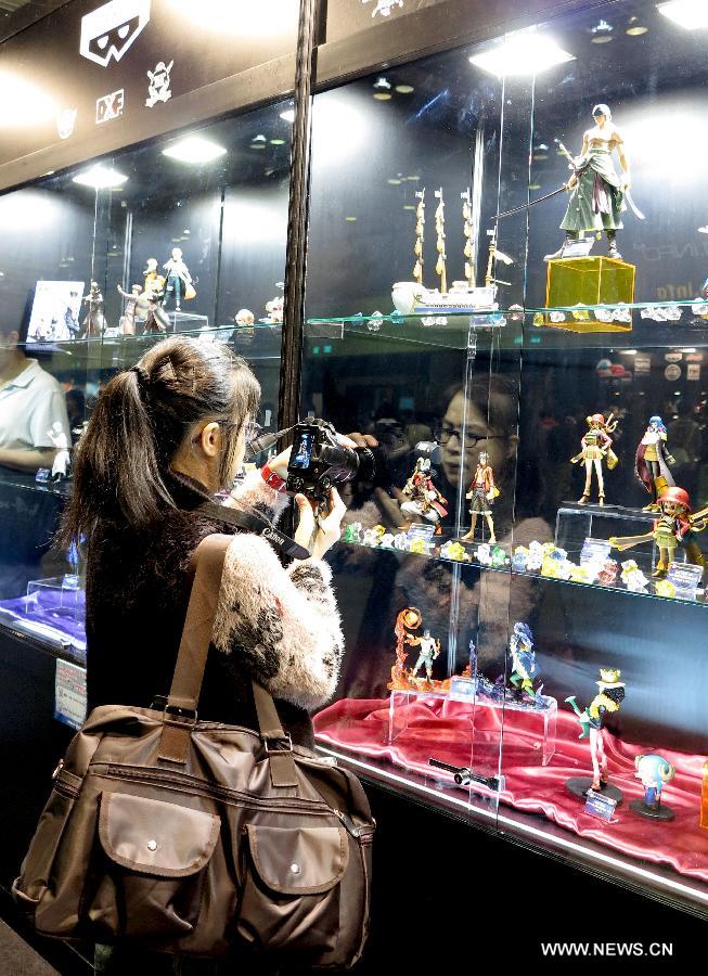 A visitor takes photos of scale model kits of animation characters at C3 in Hong Kong 2013, a Japanese anime (animation products) expo, in south China's Hong Kong, March 15, 2013. The three-day expo was inaugurated Friday at the Hong Kong Convention and Exhibition Centre. (Xinhua/Li Ying) 