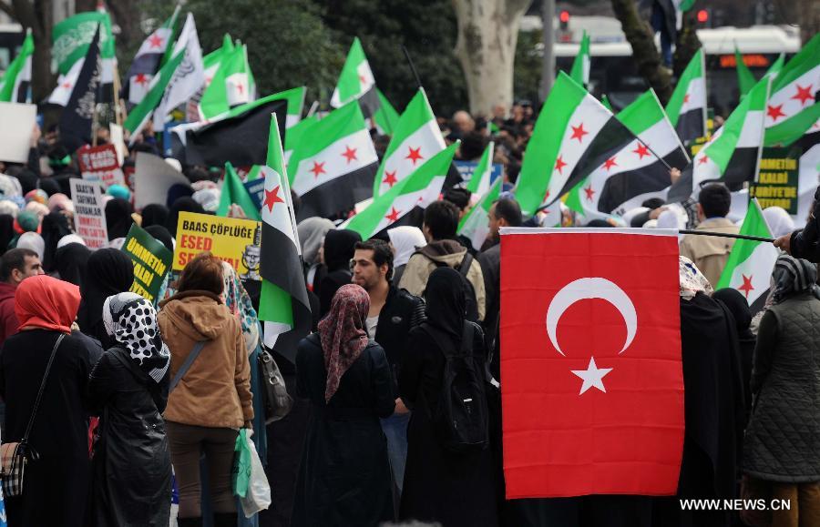 Protesters wave flags during a demonstration in Istanbul, Turkey, on March 15, 2013. More than 1,000 Turks and Syrians held a rally in Turkey's Istanbul city in protest of the Syrian government on Friday, two years after the unrest broke out in Syria. (Xinhua/Ma Yan)