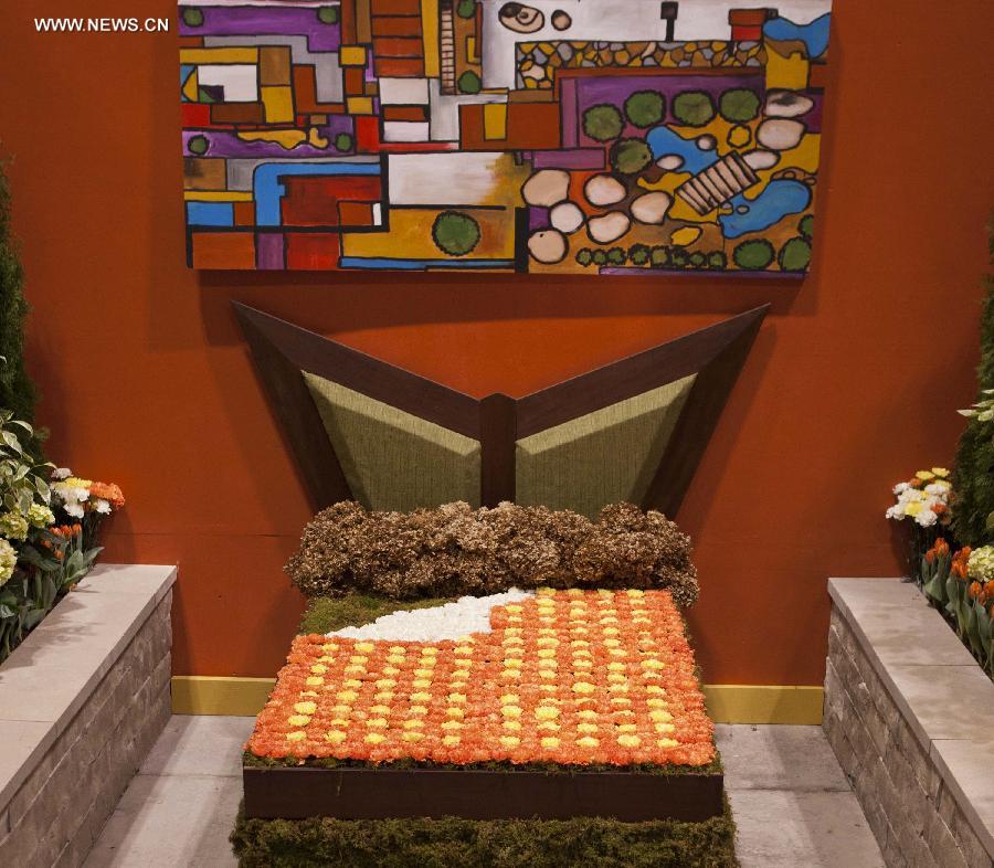 A bed made up of flowers is on display during the 17th Canada Blooms exhibition at the Canadian National Exhibition center in Toronto March 15, 2013. As Canada's largest flower and garden festival, the 10-day event kicked off on Friday and was expected to attract over 200,000 visitors. (Xinhua/Zou Zheng)