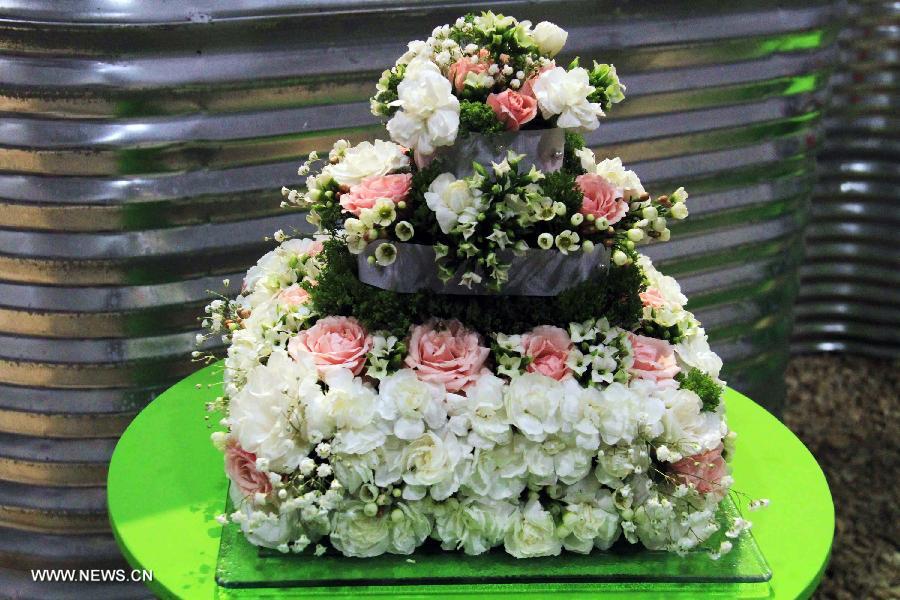 A "cake" made of plant materials is on display during the 17th Canada Blooms exhibition at the Canadian National Exhibition center in Toronto, Canada, March 15, 2013. As Canada's largest flower and garden festival, the 10-day event kicked off on Friday and was expected to attract over 200,000 visitors. (Xinhua/Ma Dan)