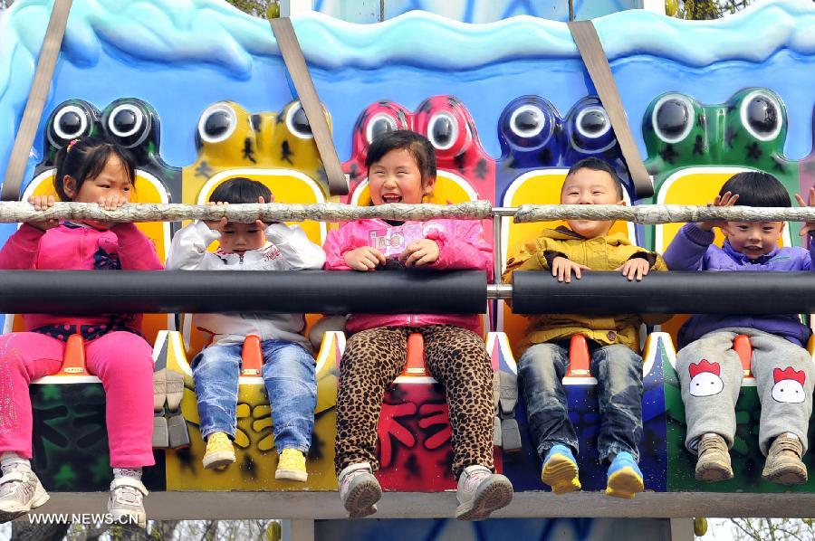 Children play at an amusement park during the early Spring in Jinan City, capital of east China's Shandong Province, March 16, 2013. (Xinhua/Guo Xulei) 