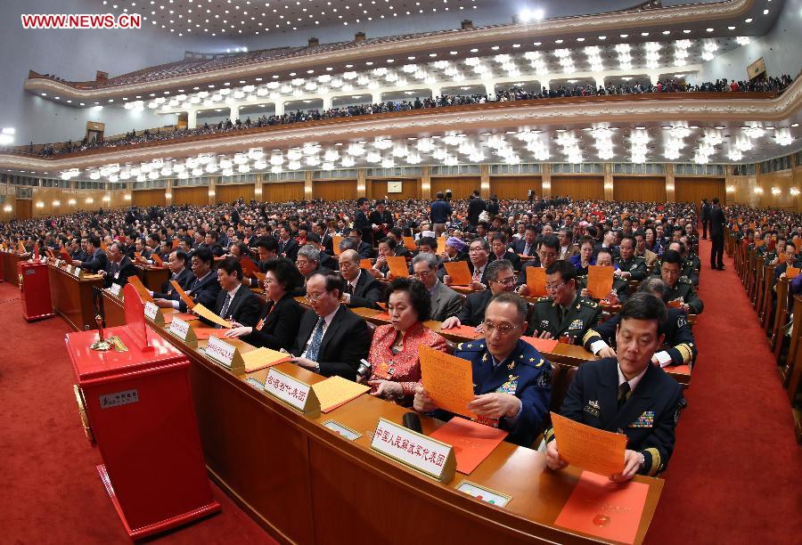Deputies check voting sheets during the sixth plenary meeting of the first session of the 12th National People's Congress (NPC) at the Great Hall of the People in Beijing, capital of China, March 16, 2013. (Xinhua/Pang Xinglei) 