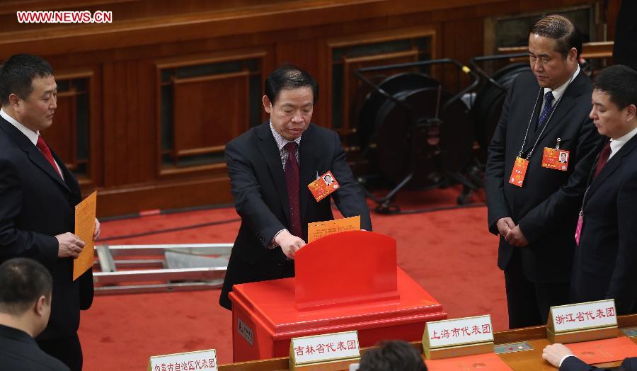 A deputy casts his vote during the sixth plenary meeting of the first session of the 12th National People's Congress (NPC) at the Great Hall of the People in Beijing, capital of China, March 16, 2013. (Xinhua/Jin Liwang) 
