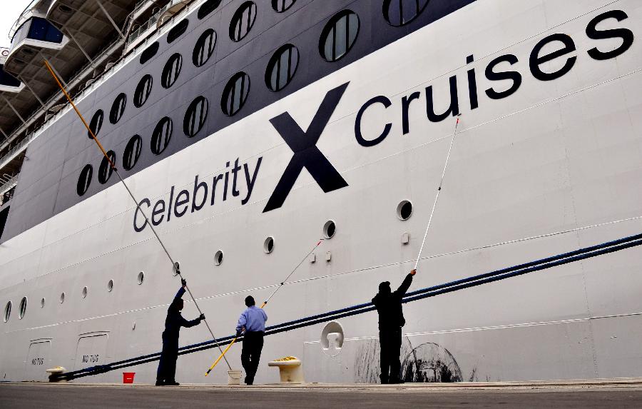 Crew members clean the cruise ship GTS Millennium at the Kai Tak Cruise Terminal in south China's Hong Kong, March 16, 2013. GTS Millennium arrived at Hong Kong's Kai Tak Cruise Terminal on Saturday and became the first cruise ship to berth at the terminal prior to its official opening in June 2013. (Xinhua/Chen Xiaowei) 