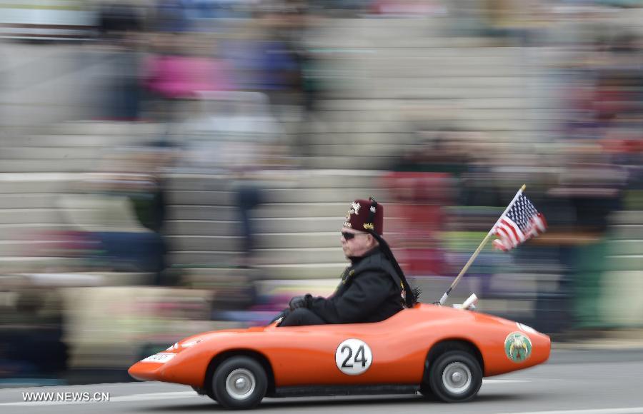 A man drives a mini car during the annual St. Patrick's Parade in Washington D.C., capital of the United States, March 17, 2013. (Xinhua/Zhang Jun)