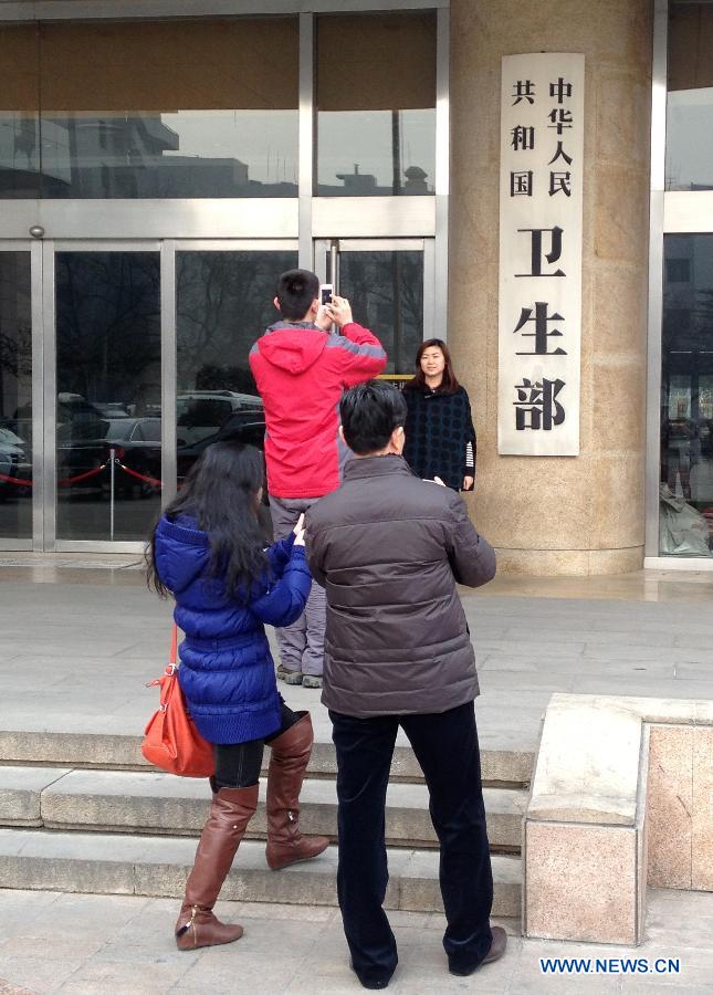 Citizens take photos in front of the Ministry of Health in Beijing, capital of China, March 15, 2013. The newly-founded National Health and Family Planning Commission hung out its name plaque on Sunday morning, replacing the name plaque of the now-defunct Ministry of Health. (Xinhua/Lv Nuo)