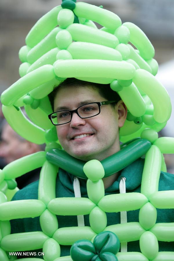 A man dressed in green balloons attends the celebration of St. Patrick's Day at Trafalgar Square in London, March 17, 2013. (Xinhua/Bimal Gautam) 