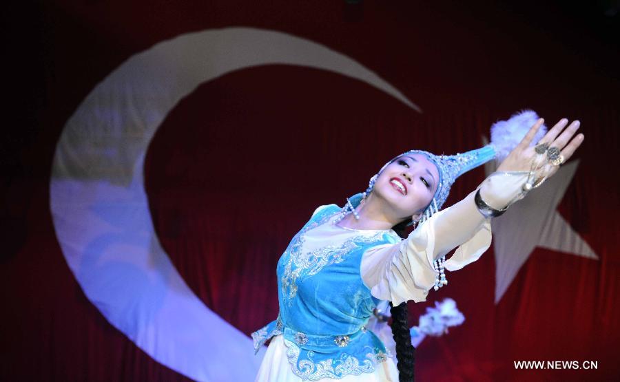 An artist performs on stage at Nevruz celebrations in Istanbul, Turkey, on March 17, 2013. The Nevruz performance, organized by the Joint Administration of Turkic Arts and Culture (TURKSOY), brings together more than 250 artists from different countries or regions to celebrate Nevruz in 15 cities of Turkey. (Xinhua/Ma Yan)