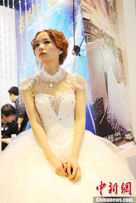Models demonstrate wedding dresses all girls are dreaming for at the 2013 Beijing Wedding Expo for spring held in National Conference Center, March 16, 2013. The expo lasted for two days. (Photo/CNS)