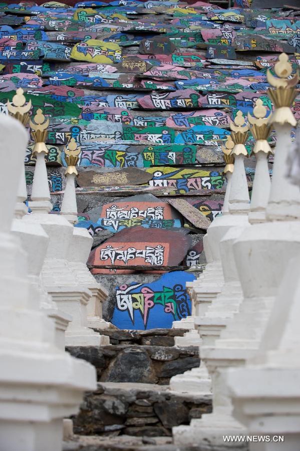 Photo taken on March 17, 2013 shows Mani stones, on which buddhist mantras are inscribed, outside the Guanyin Temple in Jinchuan County, Aba Tibetan Autonomous Region, southwest China's Sichuan Province. The temple was first build in the seventh century and hosts the shrine to the Four-Armed Avalokitesvara boddhisattva. (Xinhua/Jiang Hongjing)