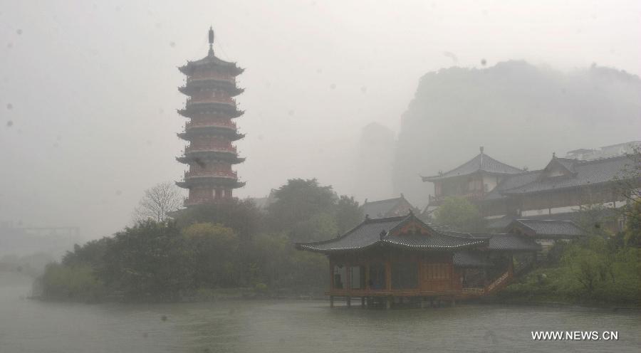 Photo taken on March 17, 2013 shows a pagoda in light fog in Guilin, southwest China's Guangxi Zhuang Autonomous Region. Guilin, a famous tourist resort, boasts of numerous cultural relics and various Karst land features. (Xinhua/Lu Bo'an) 