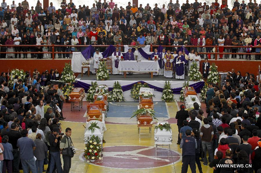 Relatives and friends attend a mass funeral for victims of a fireworks accident at the village of Nativitas in Tlaxcala state, Mexico, on March 17, 2013. At least 13 people were killed and 154 others injured when a truck containing fireworks exploded during a Catholic procession in honor of a local patron saint. (Xinhua/Juan Mateo) 