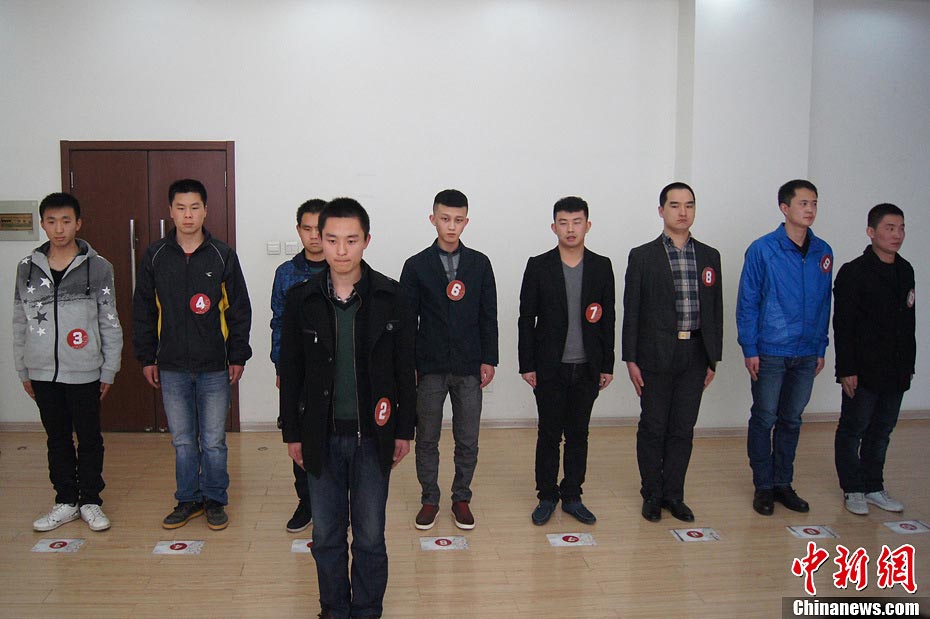 Candidate are in a test held to recruit flight security officers for Hainan Airlines, China's fourth largest airline, Taiyuan, northern China's Shanxi province on March 16, 2013. The airlines favored applicants who are graduates from military or police school or veterans. Besides appearance, applicants' manners, psychological quality in the interview, fighting skills and physical strength are also examined, which are essentials for flight security officers to deal with any emergent matter and security threat immediately. (Photo/CNS)  