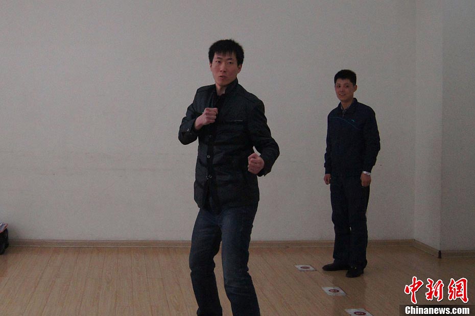 A candidate shows fighting skills for a test held to recruit flight security officers for Hainan Airlines, China’s fourth largest airline, Taiyuan, northern China’s Shanxi province on March 16, 2013. The airlines favored applicants who are graduates from military or police school or veterans. Besides appearance, applicants’ manners, psychological quality in the interview, fighting skills and physical strength are also examined, which are essentials for flight security officers to deal with any emergent matter and security threat immediately. (Photo/ CNS)  
