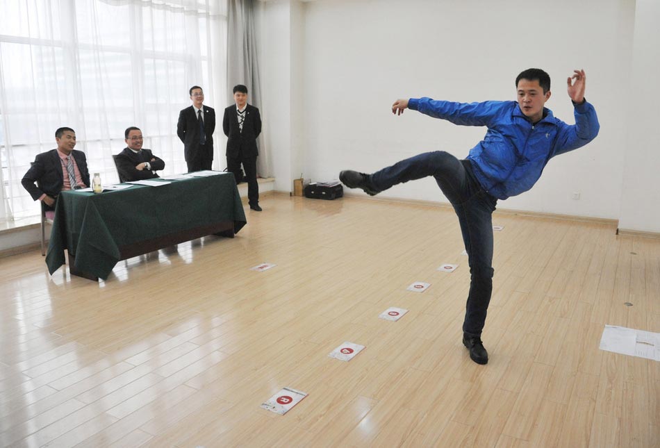 A candidate shows fighting skills for a test held to recruit flight security officers for Hainan Airlines, China's fourth largest airline, Taiyuan, northern China's Shanxi province on March 16, 2013. The airlines favored applicants who are graduates from military or police school or veterans. Besides appearance, applicants' manners, psychological quality in the interview, fighting skills and physical strength are also examined, which are essentials for flight security officers to deal with any emergent matter and security threat immediately. (Photo/ Imagine China )  