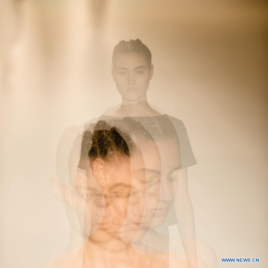 The multi-exposure photo shows a model presenting a creation of Tufi Duek during Sao Paulo Fashion Week in Sao Paulo, Brazil, March 18, 2013. The Sao Paulo Fashion Week Summer 2013/14 started here on Monday and will last for five days. (Xinhua/Weng Xinyang)