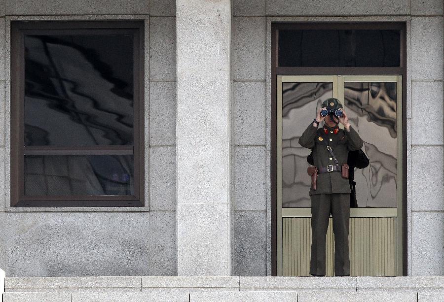 A soldier of the Democratic People's Republic of Korea (DPRK) stands guard at the truce village of Panmunjom in the demilitarized zone (DMZ) in Paju, South Korea, March 19, 2013. The annual joint military exercises of South Korea and the United States is scheduled to run from March 11 to March 21. (Xinhua/Park Jin-hee) 