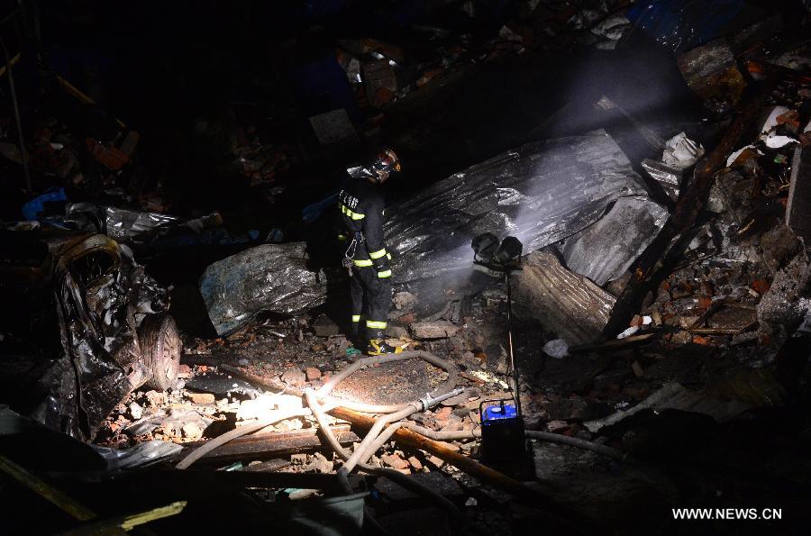 Fire fighters work at the blast locale of a residential building in Wuhan, capital of central China's Hubei Province, March 19, 2013. An explosion ripped through a residential building in Wuhan Tuesday night. Casualties from the blast that broke out at around 10 p.m. in Hanlai Square in the city's Hankou District are still unknown. (Xinhua/Cheng Min)