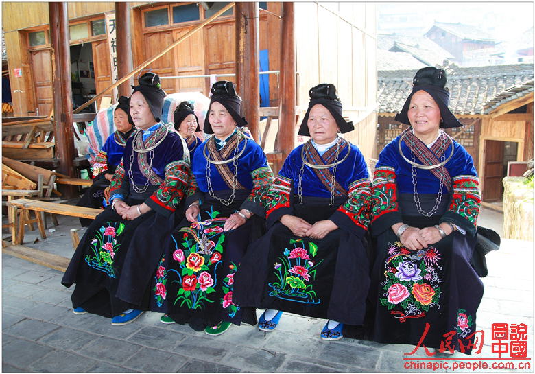 Miao women dressed in exotic Miao costumes are ready to present their colorful traditions to visitors.