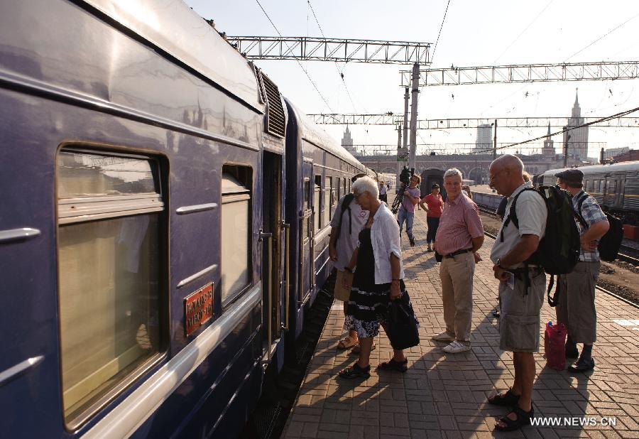 Tourists step on the first tourist trains from Russia's capital of Moscow to the Chinese capital of Beijing at the Kazan railway station in Moscow Aug. 15, 2011. The China-Russia cooperation in tourism has substantially progressed, which also has promoted bilateral understandings and exchange of culture in recent years. The Year of Chinese Tourism in Russia in 2013 will be inaugurated by Chinese President Xi Jinping when he visits Moscow later this month. (Xinhua/Jiang Kehong)