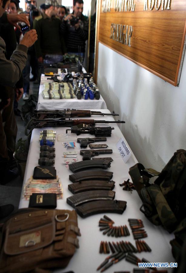 Police display arms and ammunition recovered from arrested militants during a press conference in Srinagar, summer capital of Indian-controlled Kashmir, March 19, 2013. The police chief of Indian-controlled Kashmir Abdul Gani Mir said on Wednesday that the police had cracked a terrorist attack on a paramilitary camp on March 13 in which five security forces personnel were killed and eight others injured. Four people involved in the attack were arrested. (Xinhua/Javed Dar)