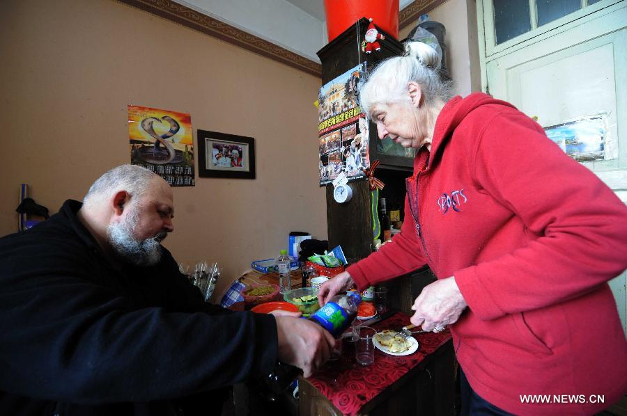 Eremin Sergei and his mother prepare for lunch in his dormitory on the Sun Island in Harbin, capital of northeast China's Heilongjiang Province, March 15, 2013. (Xinhua/Wang Jianwei) 