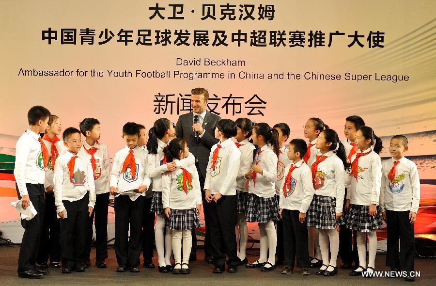 British footballer David Beckham (Back) reacts at a press conference in Beijing, capital of China, on March 20, 2013. David Beckham came to China as the ambassador for the youth football program in China and the Chinese Super League (CSL). (Xinhua/Cao Can)