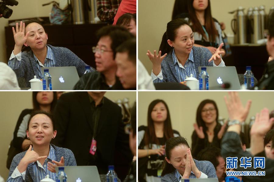 Photo shows dumb dancer Tai Lihua expressing suggestions by finger language on March 4 at a panel discussion during the first session of the 12th CPPCC National Committee.  (Xinhua/ Jin Liangkuai)