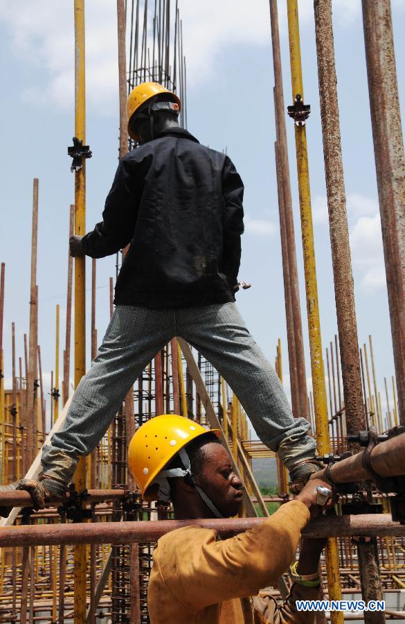 Local workers are hang scaffolds at the site of Kpong Water Project in Kpong town, Great Accra region, Ghana, on March 19. Due to the aging water supply facilities and mis-management, Ghana's capital Accra is facing severe shortage of water. A 270-million U.S. dollars loan facility financed by the Export-Import Bank of China was carried out on June, 2011 for the expansion works at the Kpong Water Project. This project will ensure an additional supply of 20,000 tons of water daily to Accra and its environs and contribute a lot to help Ghana to achieve the Millennium Development Goals .(Xinhua/Shao Haijun) 